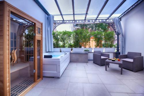 a large bathroom with a tub and a large window at Villa Elisio Hotel & Spa in Naples