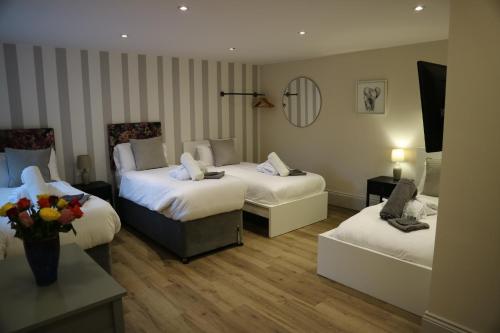 a hotel room with two beds and a couch at No 9 The Folly in Southport