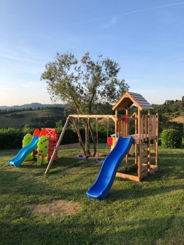 a playground with two swings and a slide at "Villa Bizzi" in Monte Castelli