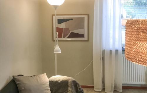 a floor lamp in a living room next to a couch at Amazing Apartment In Kvillsfors in Kvillsfors