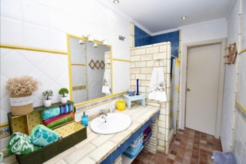 łazienka z umywalką i lustrem w obiekcie Villa Mencal w mieście Chiclana de la Frontera