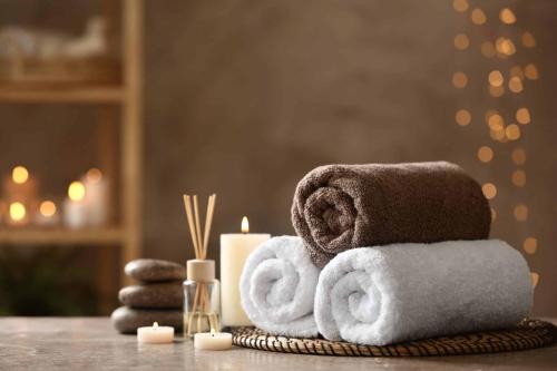 a pile of towels and candles on a table at Seyithan Palace Spa Hotel in Istanbul
