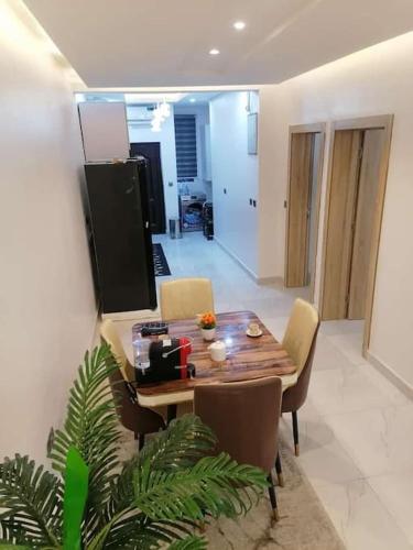 a dining table and chairs in a living room at Beautiful 2 bedroom in Ologolo in Lekki