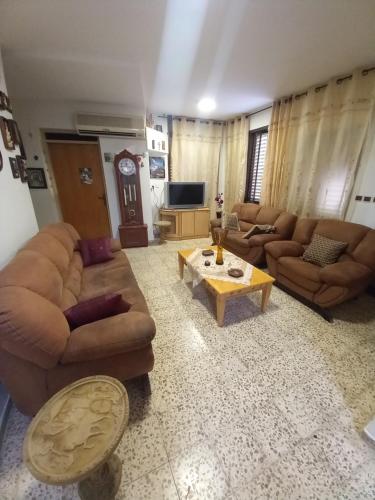 Sala de estar con sofás y mesa de centro en Villa Cana, en Kafr Kannā