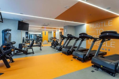 a gym with a bunch of tread machines in it at Cityhome Platina Tatuapé in Sao Paulo