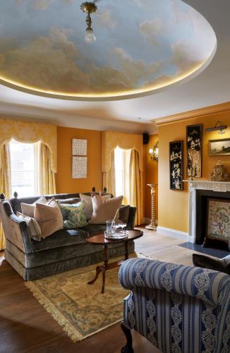 a living room with a couch and a table at The Zetter Marylebone in London