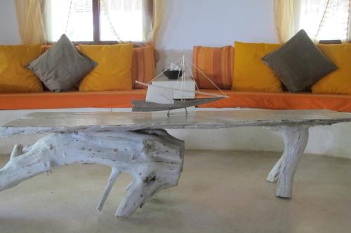 a wooden table with a boat on top of it at Baobab Village in Watamu
