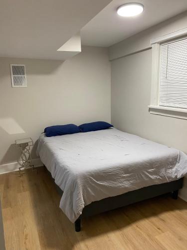 a bedroom with a bed in a white room at Lincoln Park Apartment with Backyard! in Chicago