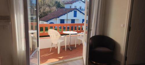 a view of a balcony with a table and chairs at Hotel Uhainak in Hendaye