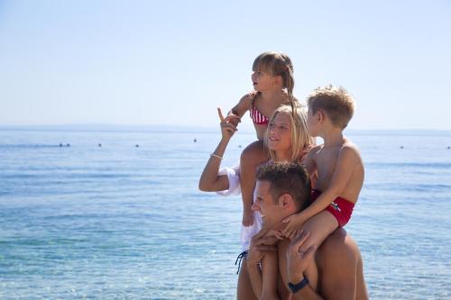 a group of children standing on the beach at Remisens CASA ROSA - Hotel Metropol Annexe in Portorož