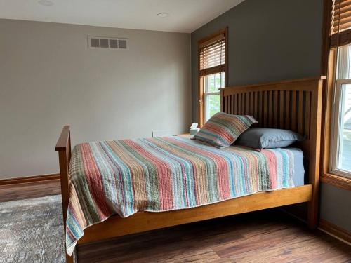 a bedroom with a bed with a striped comforter at Private, great loc - ideal for long / short stay in Canton