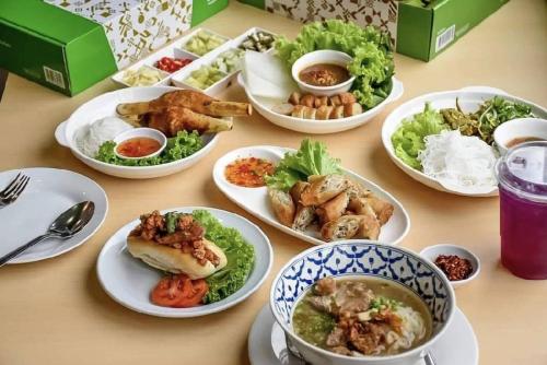 a table topped with plates of food on a table at BJ city hotel in Surat Thani