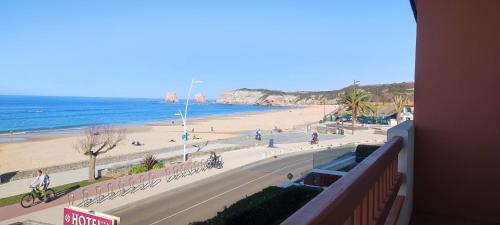 a view of a beach from a balcony of a building at Hotel Uhainak in Hendaye