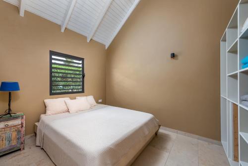 a bedroom with a bed and a window at Kura Kabana Resort in Kralendijk