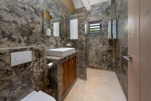 a bathroom with a sink and a mirror at Kura Kabana Resort in Kralendijk