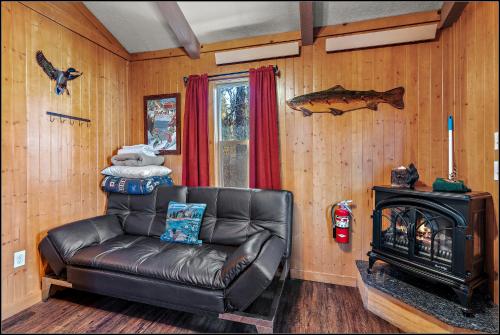 a leather couch in a living room with a stove at Brundage Bungalows in McCall