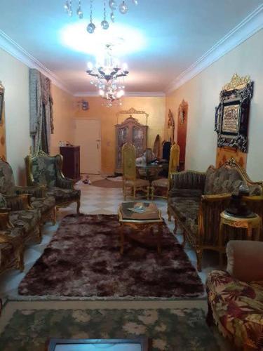 a living room filled with furniture and a chandelier at Pyramid in Cairo