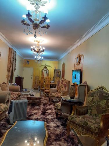 a living room filled with furniture and a chandelier at Pyramid in Cairo