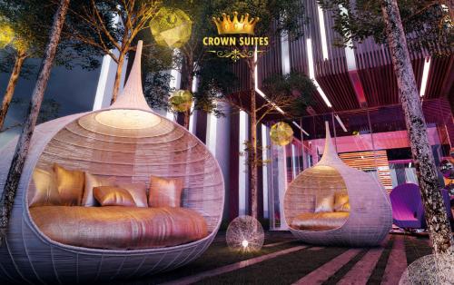 two pods with couches sitting in front of a building at Crown Suites Tropicana The Residence KLCC Bukit Bintang Kuala Lumpur in Kuala Lumpur