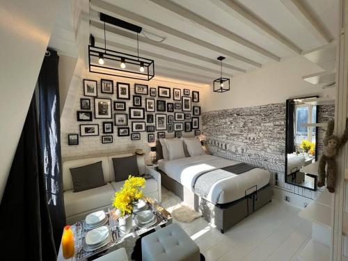 um quarto com uma cama e uma parede com fotografias em Studio tout équipé à Nation Paris XI-Tout confort em Paris