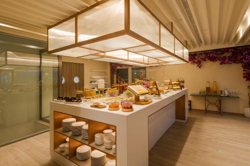 a kitchen with a counter with food on it at LUSTER Hotel in Lisbon