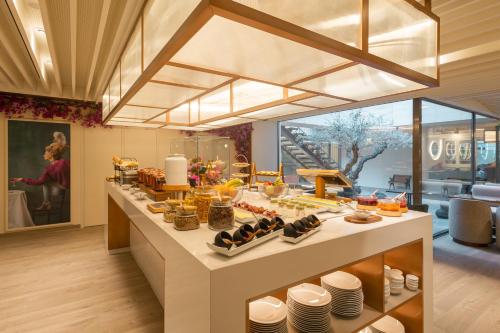 a buffet line with food on it in a restaurant at LUSTER Hotel in Lisbon