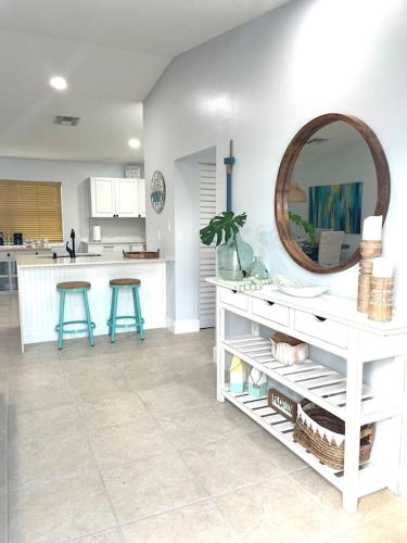 a white kitchen with a mirror and a counter at Casa Blue Flamingo - In the Florida Keys - minutes from the beach in Marathon