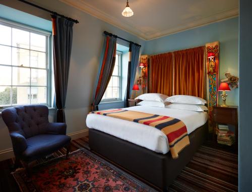a bedroom with a bed and a chair at The Zetter Clerkenwell in London