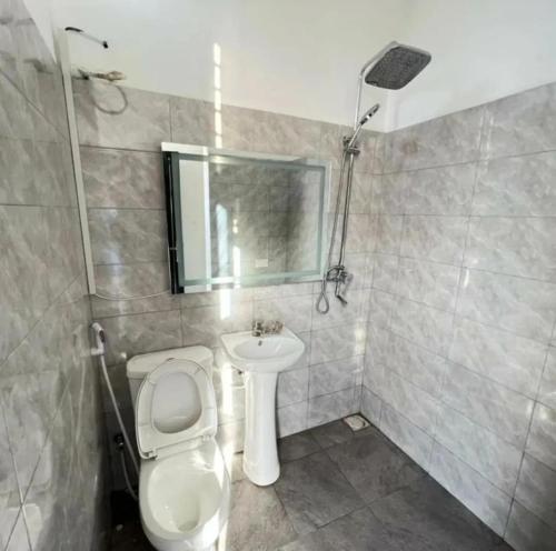 a bathroom with a toilet and a sink at Inviting 1-Bed Studio in Dar es Salaam in Dar es Salaam