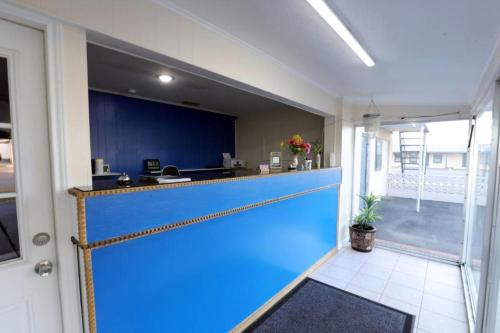 a blue garage door in a room with a kitchen at Economy Inn Kingsville in Kingsville