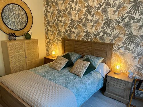 a bedroom with a bed and two night stands with candles at Le Clos Saint Fiacre in Carentoir