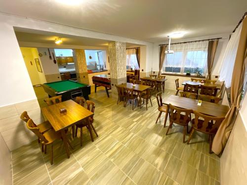 a dining room with tables and a pool table at MAXOVO KRÁLOVSTVÍ in Rovensko pod Troskami