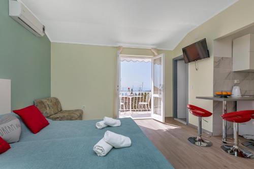 a room with a bed with towels on the floor at Villa NIKA & KARLO Makarska in Makarska