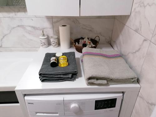a bathroom counter with towels and a washing machine at Ankara Esenboğa Airport Luxury Apart Concept in Ankara