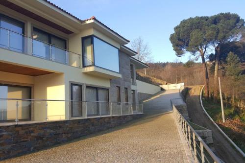a house with a balcony and a driveway at Casa das Oliveiras, o Douro no seu esplendor! in Cinfães