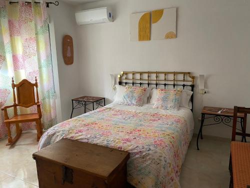 a bedroom with a large bed with a wooden table at Alojamiento Rural Samburiel in Becerril de la Sierra