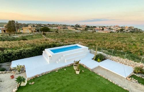 uma imagem de uma villa com piscina em B&B Casa del Faro SanVallero Adults Only em Portopalo