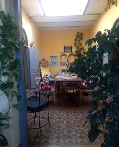 a dining room with a table and chairs at La Maison Haute Larache Morocco in Larache