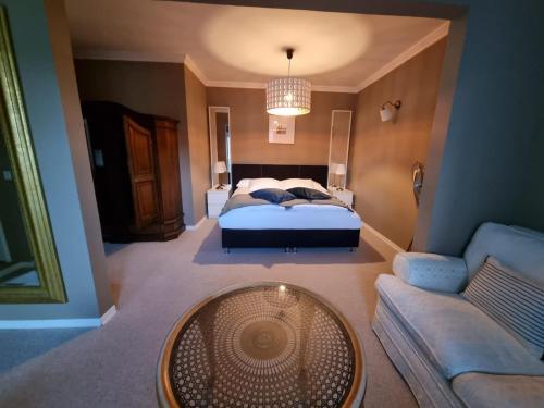 a bedroom with a bed and a couch and a table at Boutique Centrale in Brione sopra Minusio