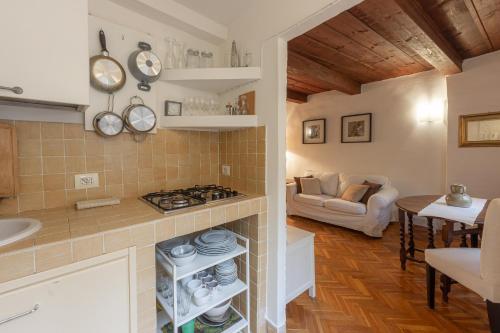 een keuken en een woonkamer met een fornuis en een bank bij Signoria Florentine Apartment in Florence