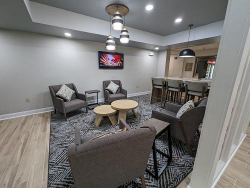 a waiting room with couches and chairs and a table at Candlewood Suites Aberdeen-Bel Air by IHG in Riverside