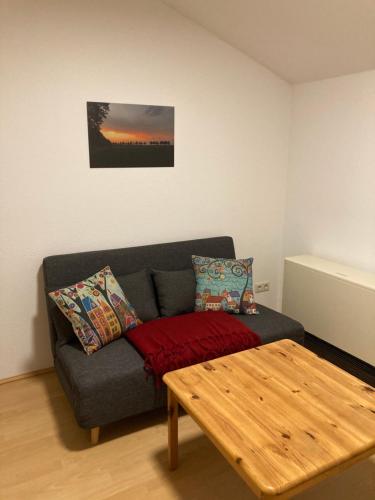 a living room with a couch and a wooden table at Ferienwohnung Zweinig 03 in Roßwein