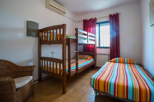 a bedroom with two bunk beds and a bed at Finca Tierra Roja in Cálig