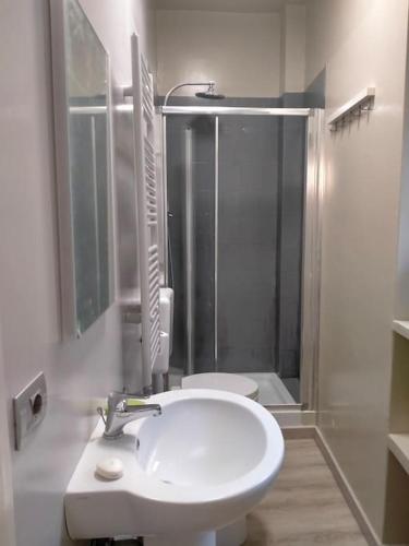 a bathroom with a white sink and a shower at Smart Home Centro Storico in Collegno