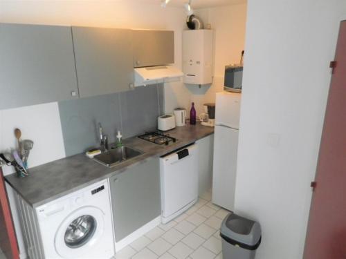 une cuisine avec un évier et une machine à laver dans l'établissement T2 PLAGE DE LA CONQUE, au Cap d'Agde