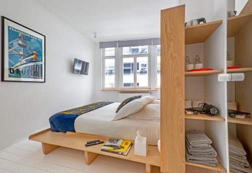 a bedroom with a bed and a book shelf at Happy guesthouse - Grand Place in Brussels