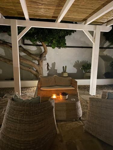 a patio with two chairs and a couch and a table at Dimora Ferralasco in Carloforte