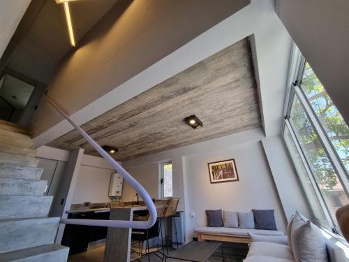 a living room with a staircase in a house at Barrancas de Nieva B03 in San Salvador de Jujuy