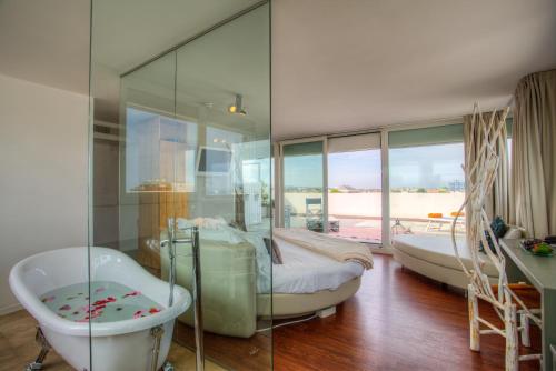 里喬內的住宿－D-Place酒店及套房，带浴缸和爪足浴缸的浴室
