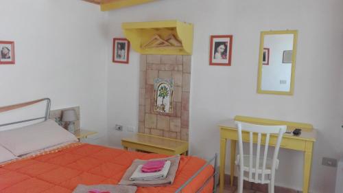 a bedroom with a bed and a desk and a table at Zagara di Sicilia in Marsala
